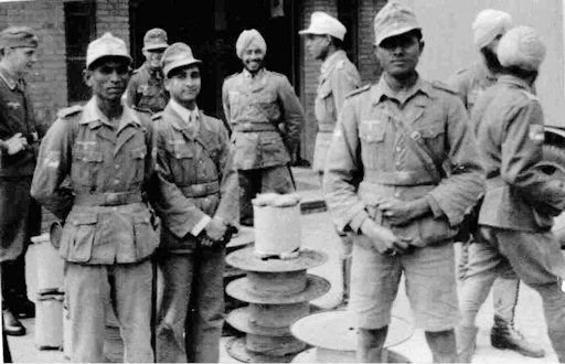 Unloading some of the Nachrichtenzugs equipment. Note the large reels of telephone cable. (War Photo Holland)